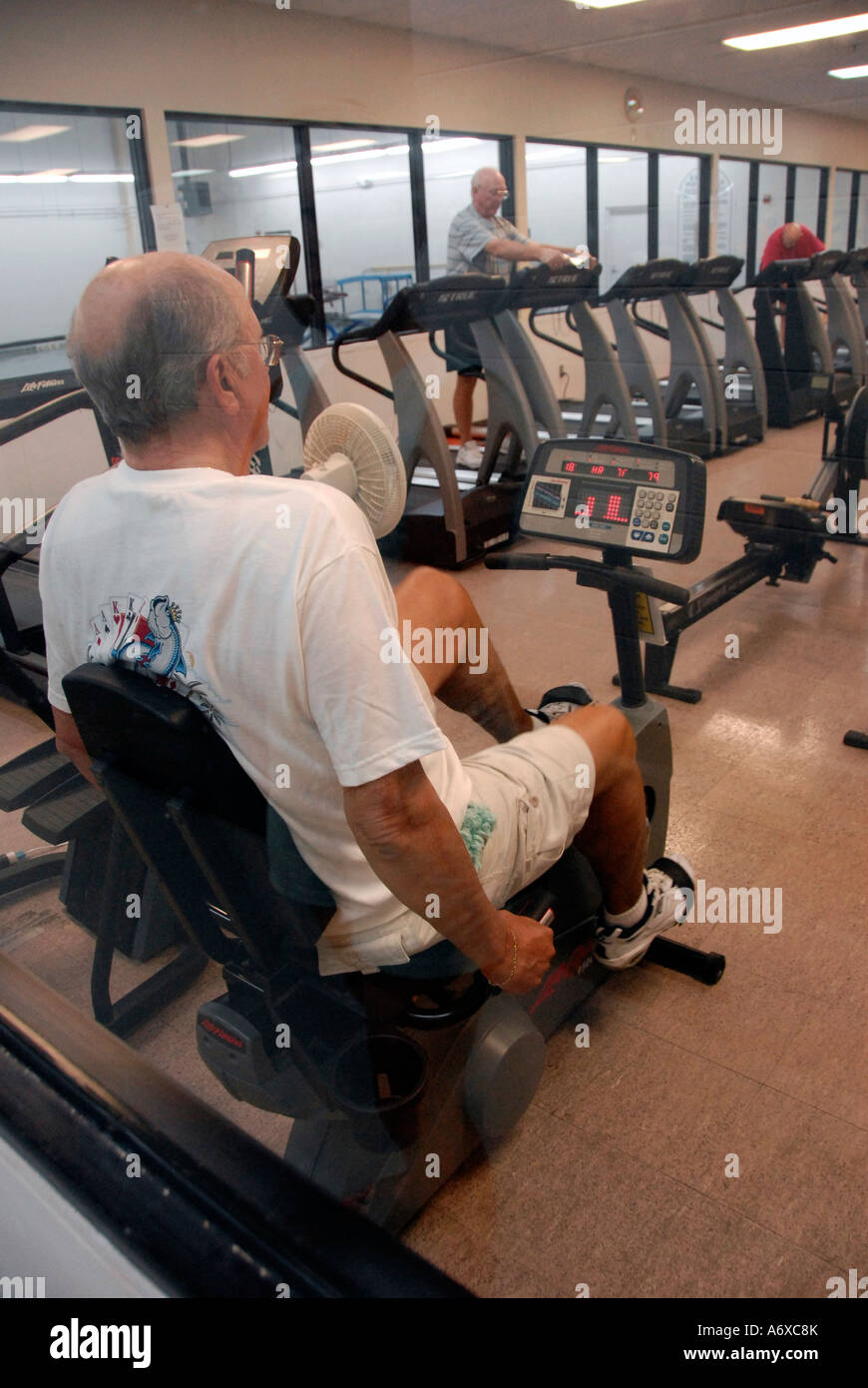 Senior citizens exercise using various exercise equipment Stock Photo ...