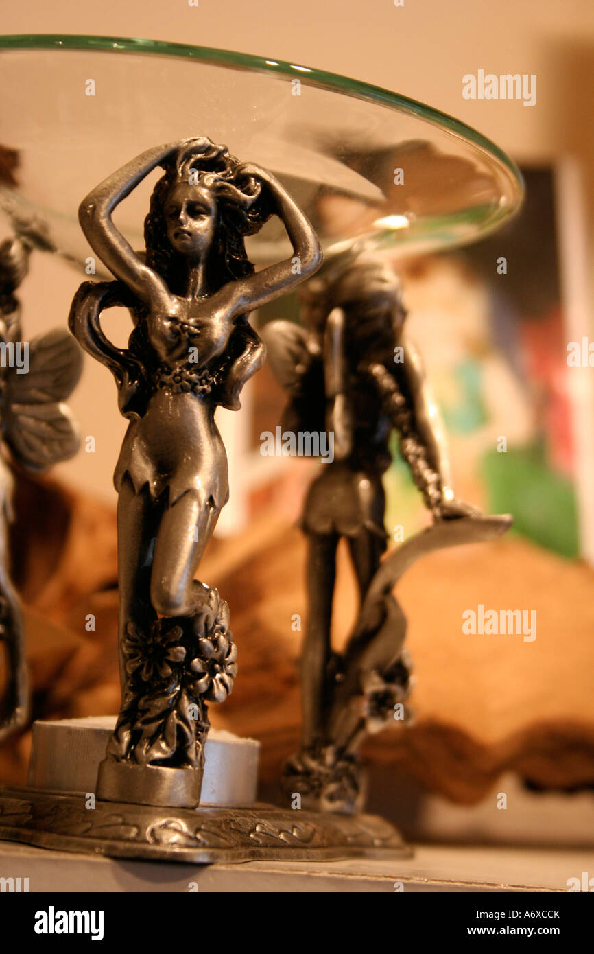 pewter fairies holding glass dish oil burner in a new age shop, malvern, Worcestershire, england uk Stock Photo