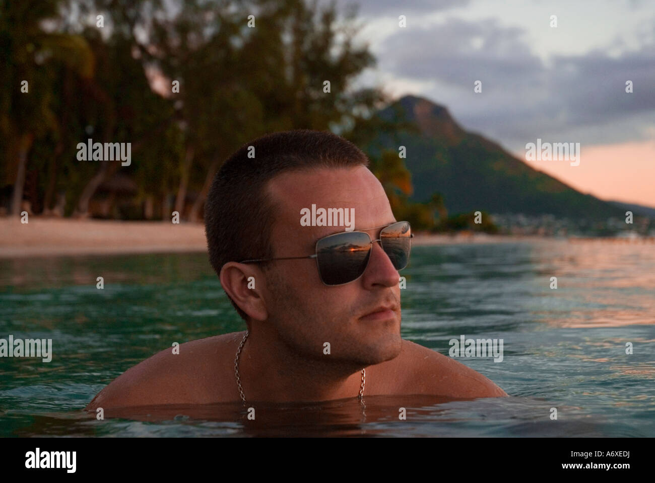 Man watching sunset in shallows off the coast of Mauritius Stock Photo ...