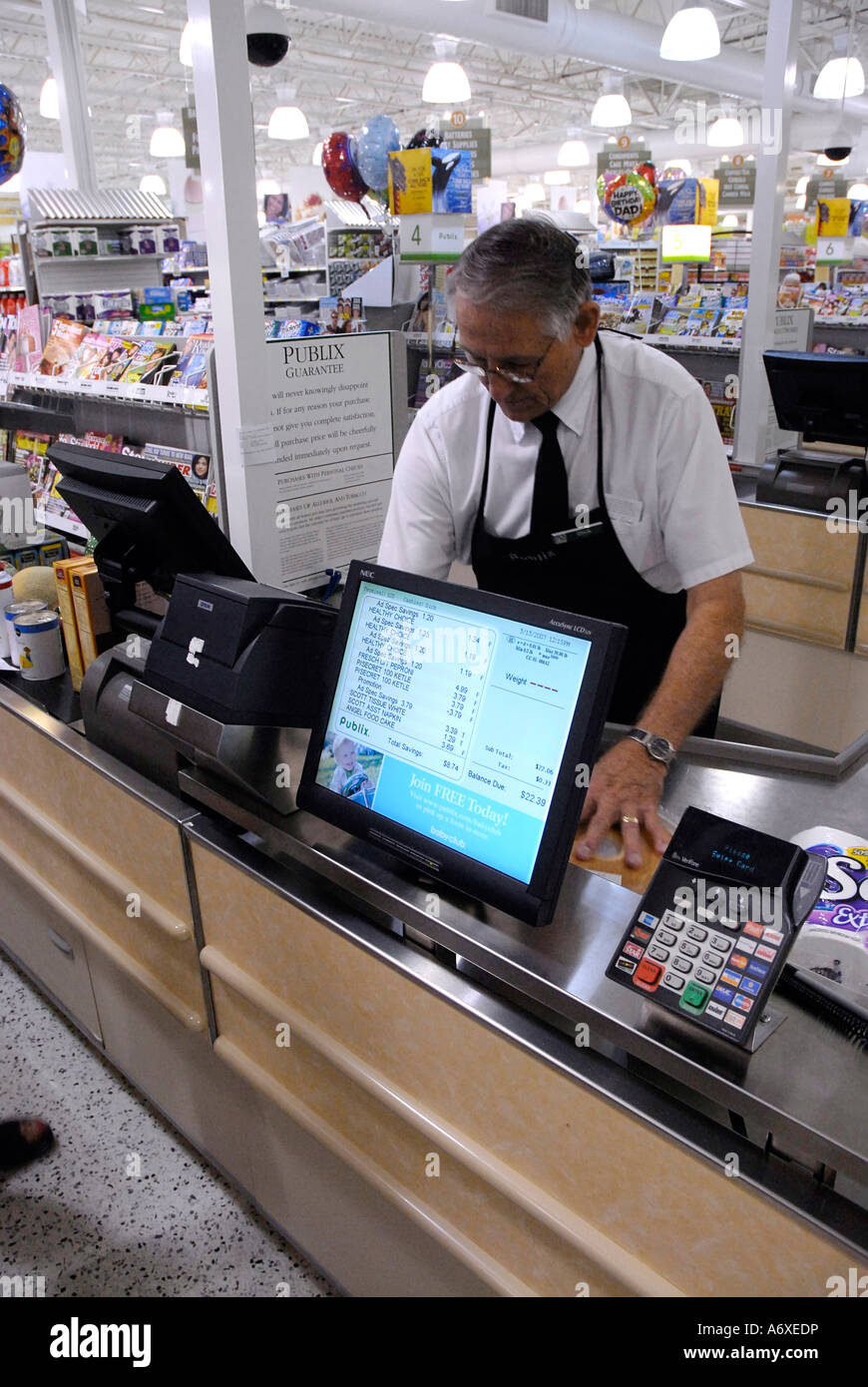 Adult female uses High tech computer checkout system involving customer as she checks out at a