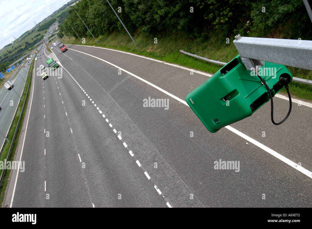 Traffic camera on motorway bridge on M62 with passing traffic in
