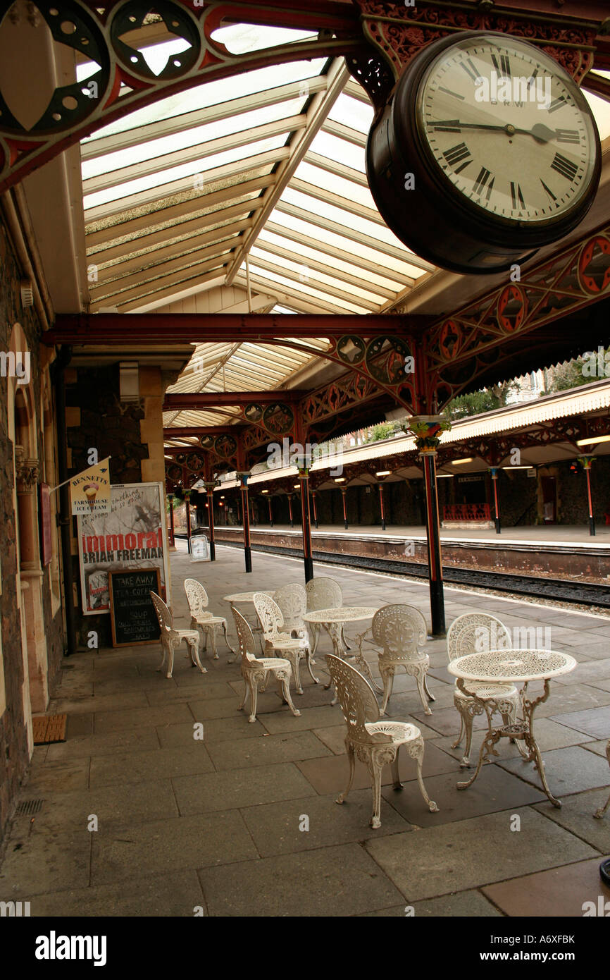 clock and cafe chairs on the platform of great malvern train station