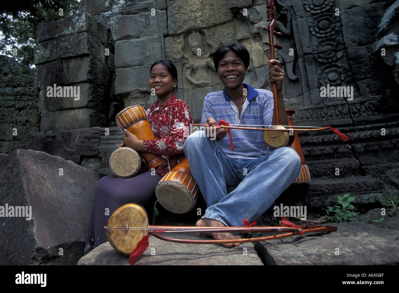 Asia, Cambodia, Ta Prohm Temple. Musicians  (MR) Stock Photo