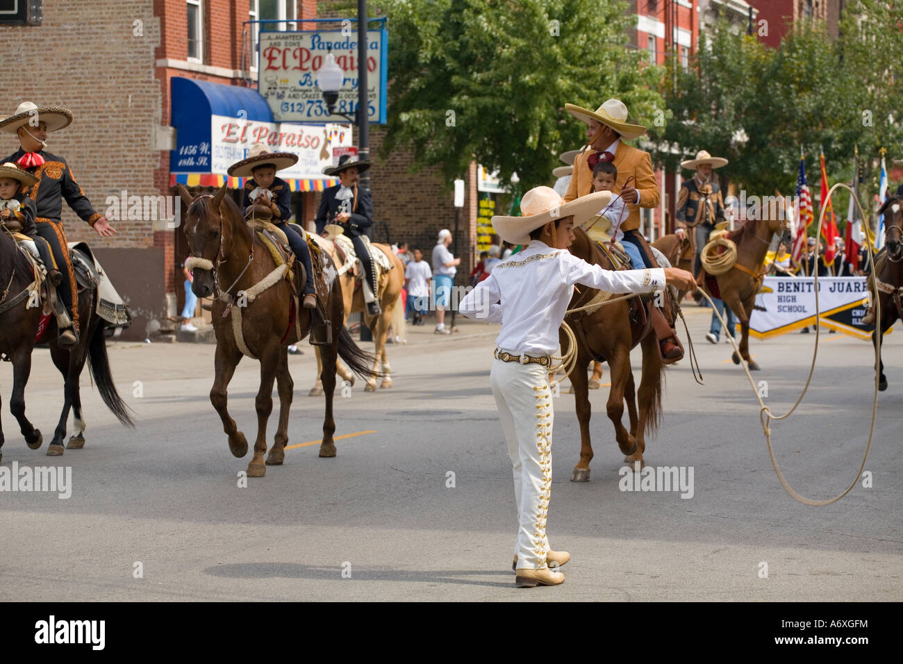 ILLINOIS Chicago Boy twirl lariat people on horseback Mexican Independence Day Parade in Pilsen neighborhood Stock Photo
