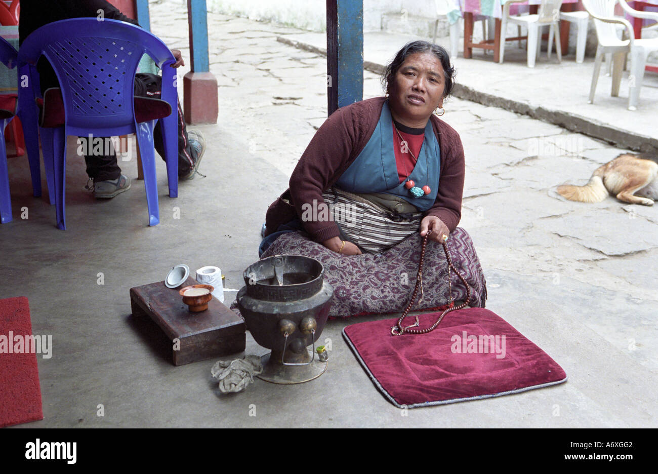 Nepali woman posing while Tibetan tea making ritual in Chamje village Annapurna Conservation Area Nepal Stock Photo
