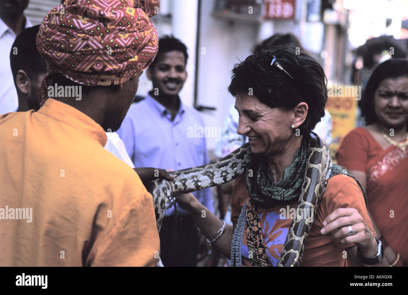 A woman dealing with serpent charmers from India featuring snake showoff in Thamel Kathmandu Nepal Stock Photo