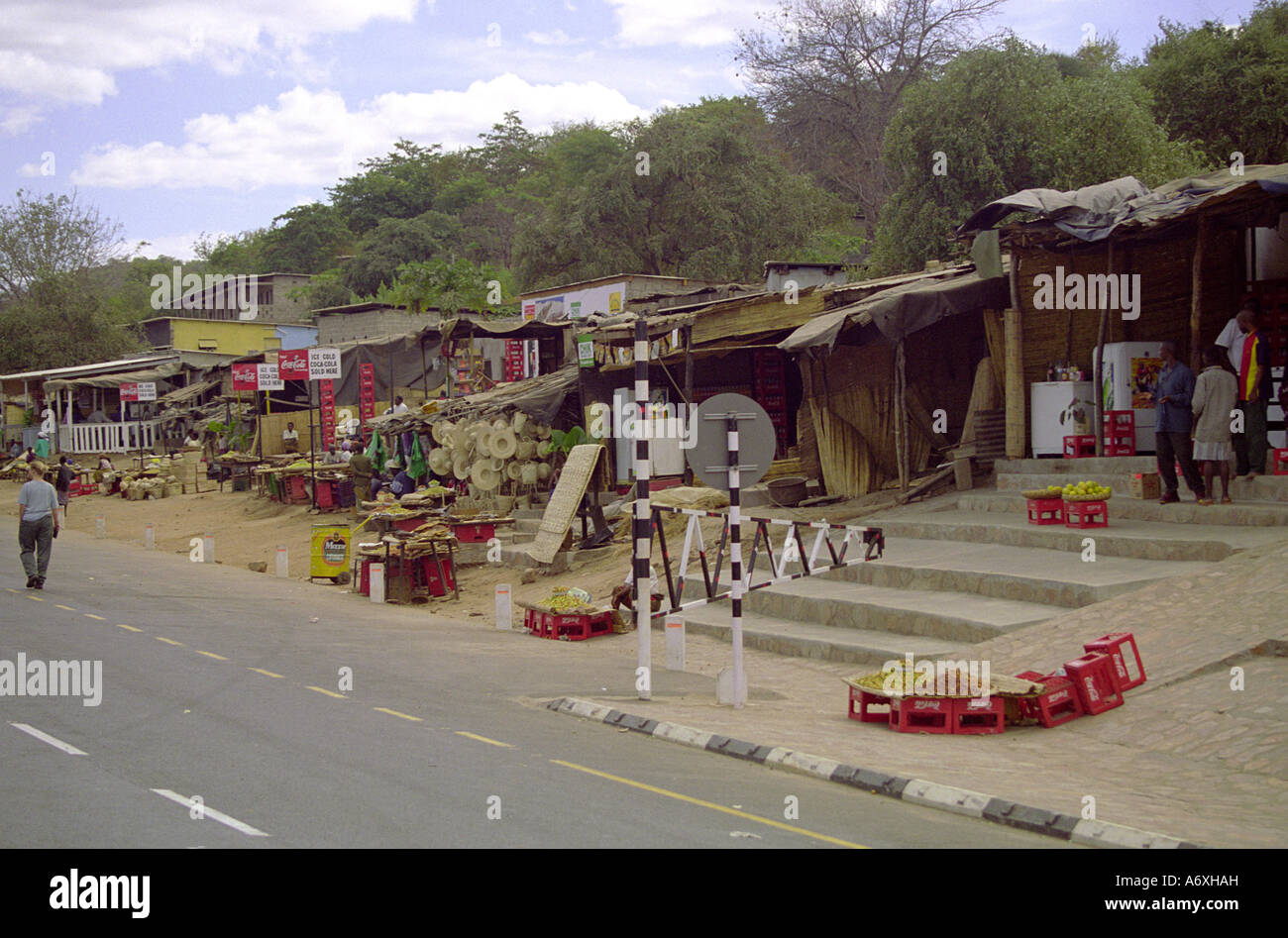 collection of huts making up a village on the roadside outside malawi river zambia Stock Photo