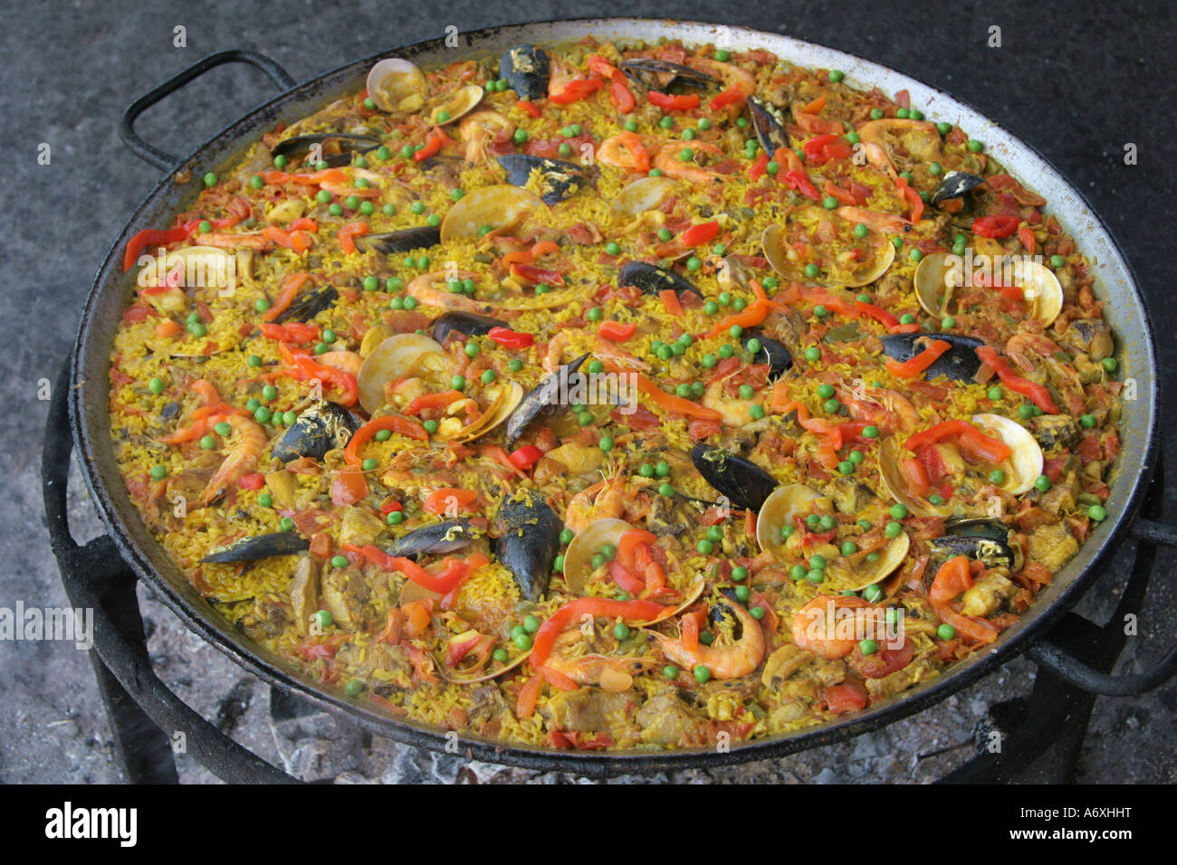 paella being cooked at spanish beach barbeque Stock Photo Alamy
