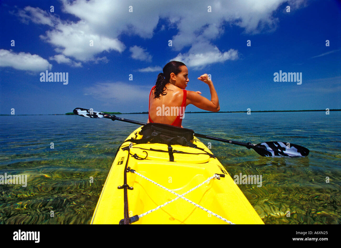 Female with Sea Kayak on the flats, Bimini Island, Bahamas.  (MR) Stock Photo