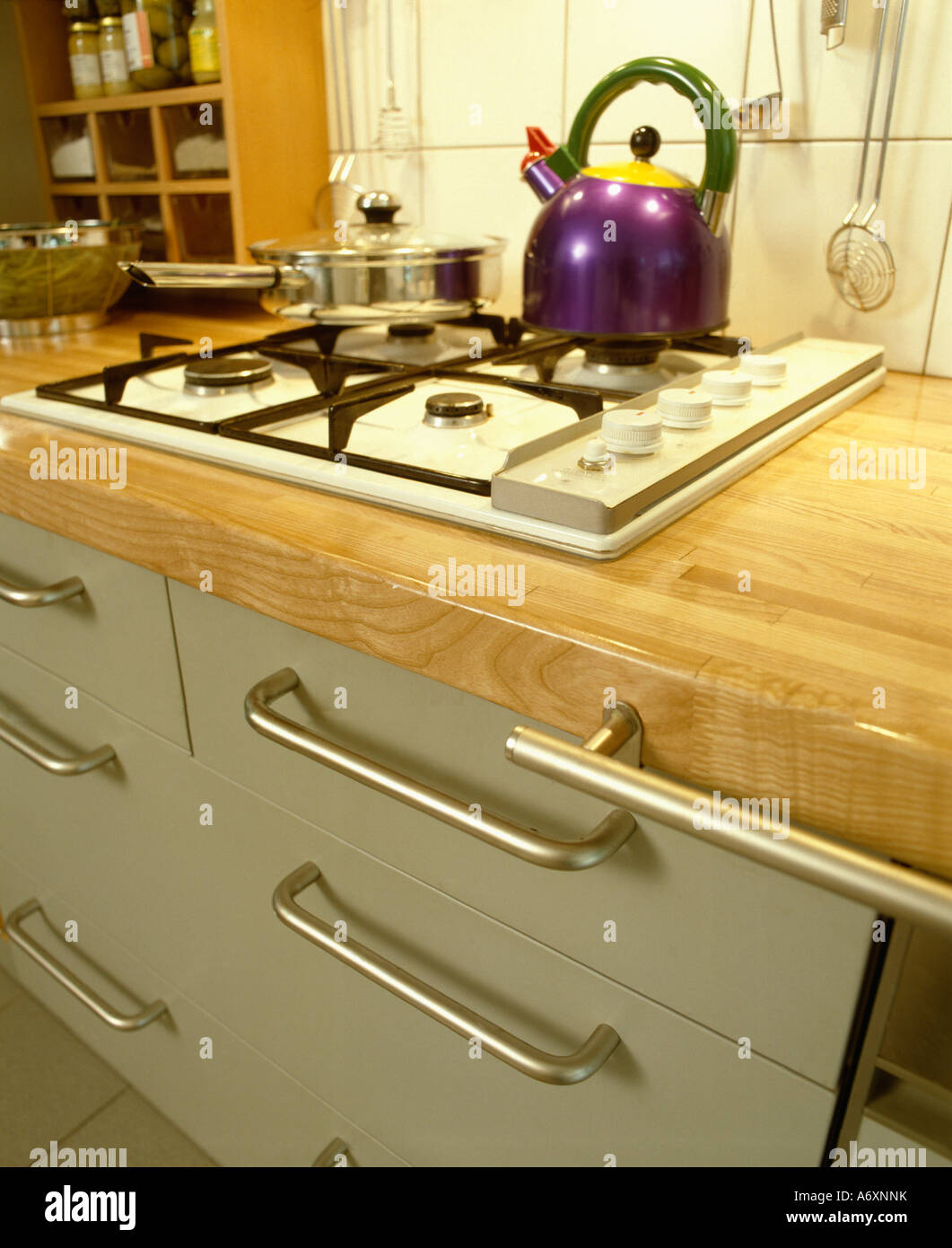 Close Up Of Purple Alessi Kettle On White Gas Hob In Kitchen
