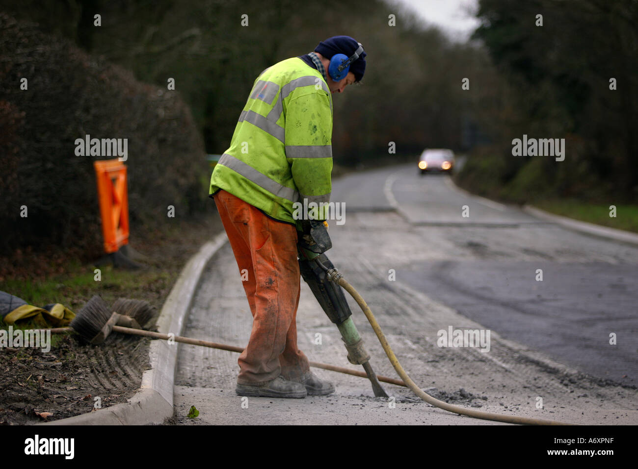 Road worker digging up tarmac Stock Photo Alamy