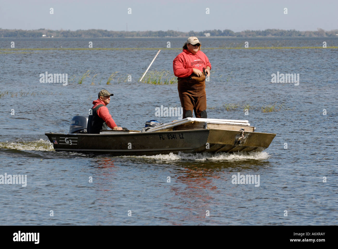 Two Boaters Enjoy Fishing on West Lake Toho in Southport Park Kissimmee Orlando Disney Theme Park Area Florida US Stock Photo