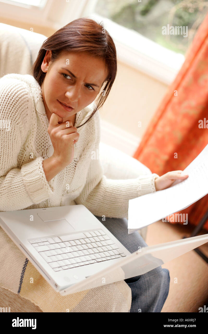 Woman working out finances online Stock Photo
