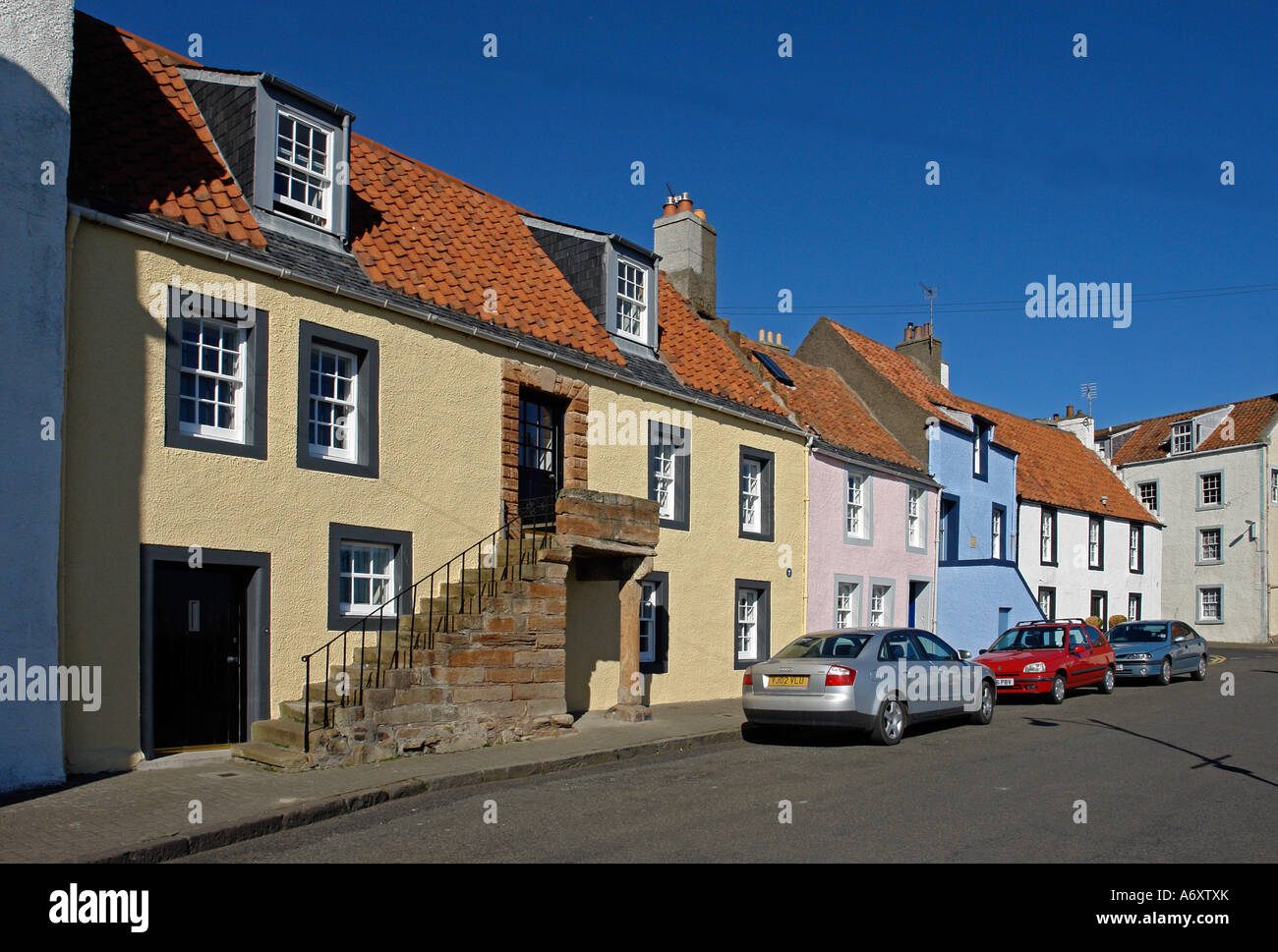 St. Monans harbour in Fife Scotland with colourful traditional houses lining the street Stock Photo