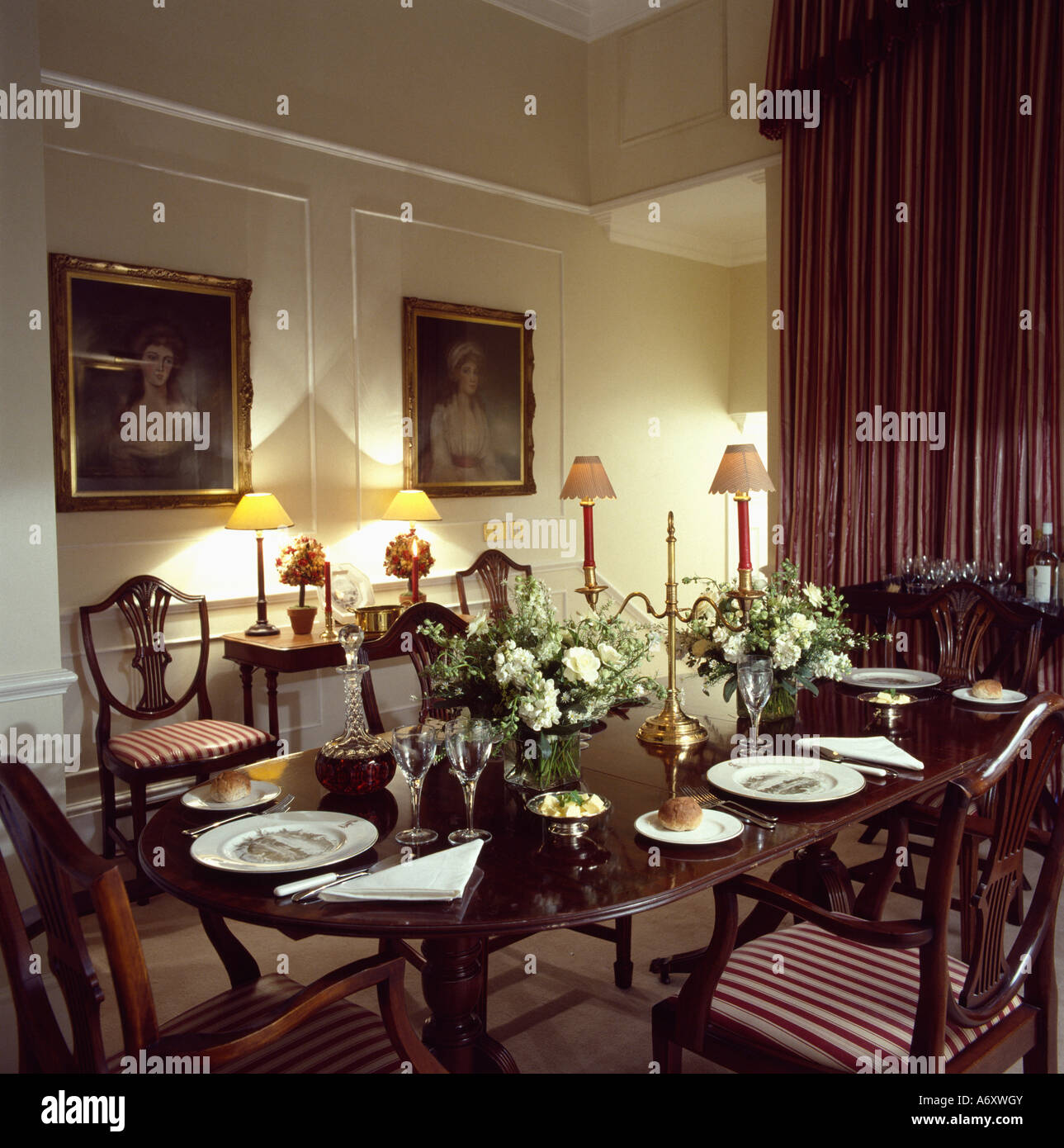 Regency Style Dining Table And Chairs In Traditional Diningroom With Lighted Lamps Stock Photo Alamy