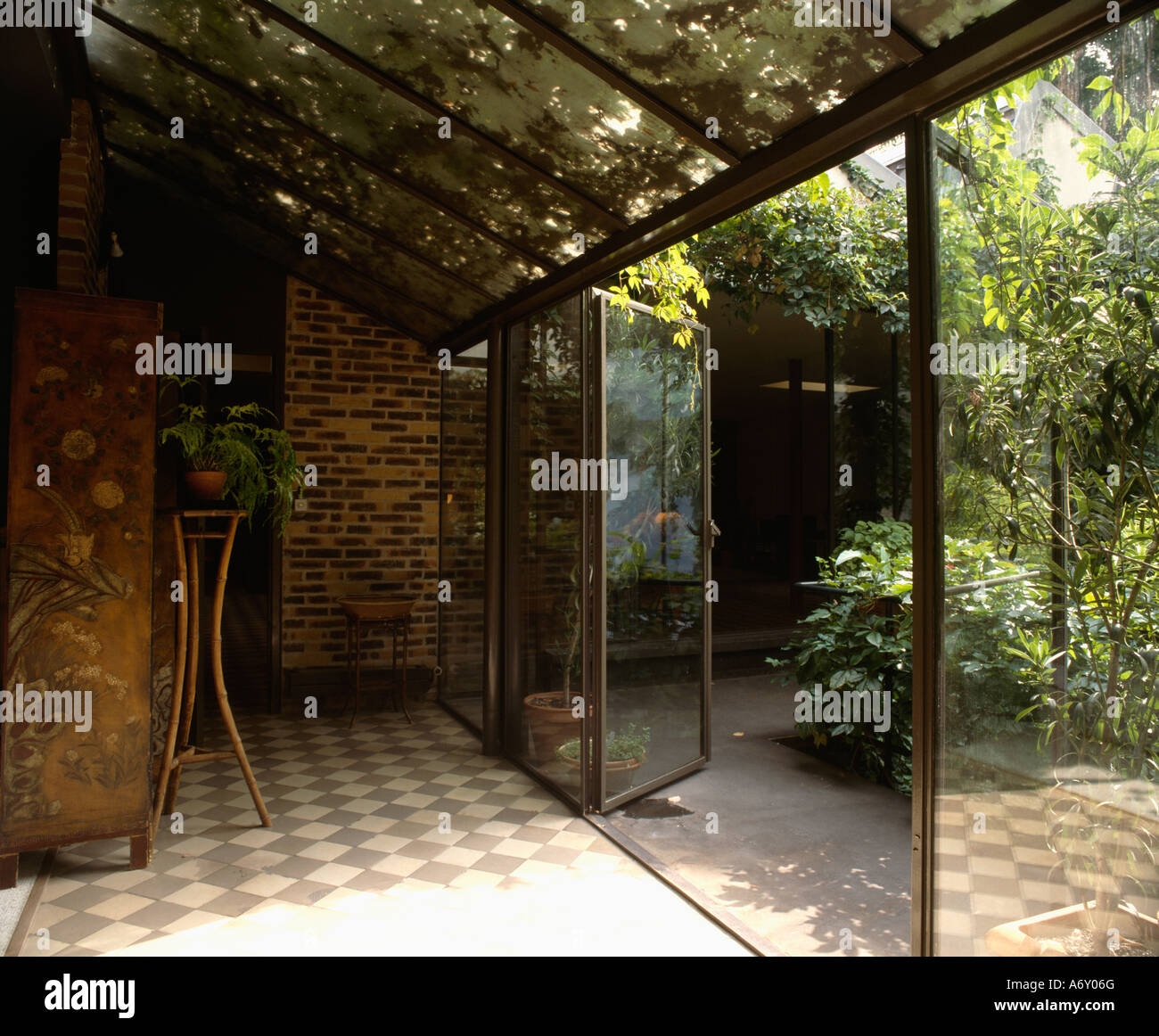 Picture of Glass roof extension with tiled floor and glass doors open to the ...