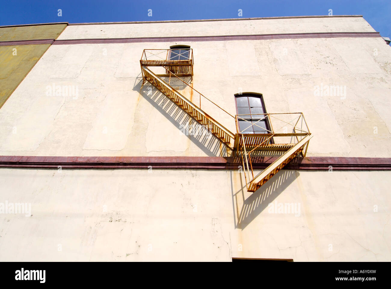 Fire escape lead from windows of a three story building to the ground Stock Photo