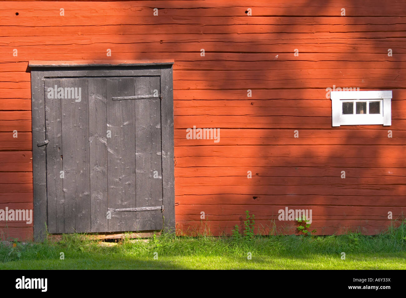 Traditional style Swedish wooden painted house. Black door. Smaland