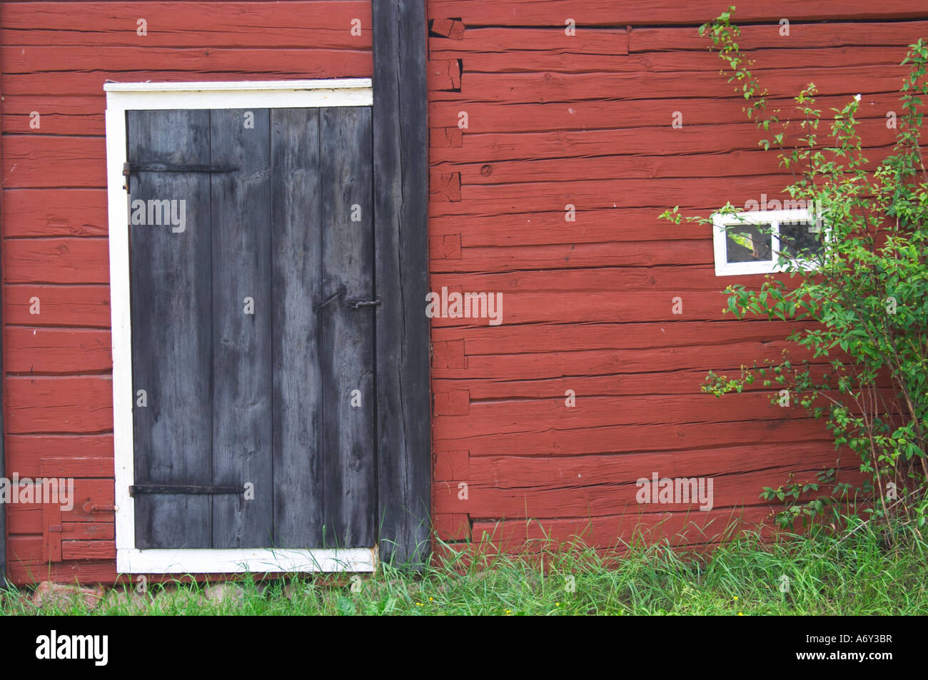 Traditional style Swedish wooden painted house. Black door. Smaland