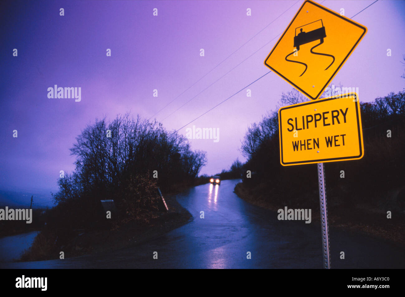 Car Driving on Wet Road Slippery When Wet Sign SC AK Fall Evening Stock Photo 2175935 Alamy