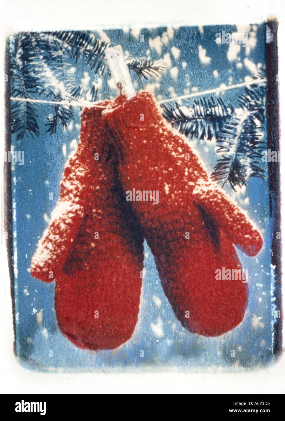 Red Mittens on Clothesline in Snowstorm Stock Photo