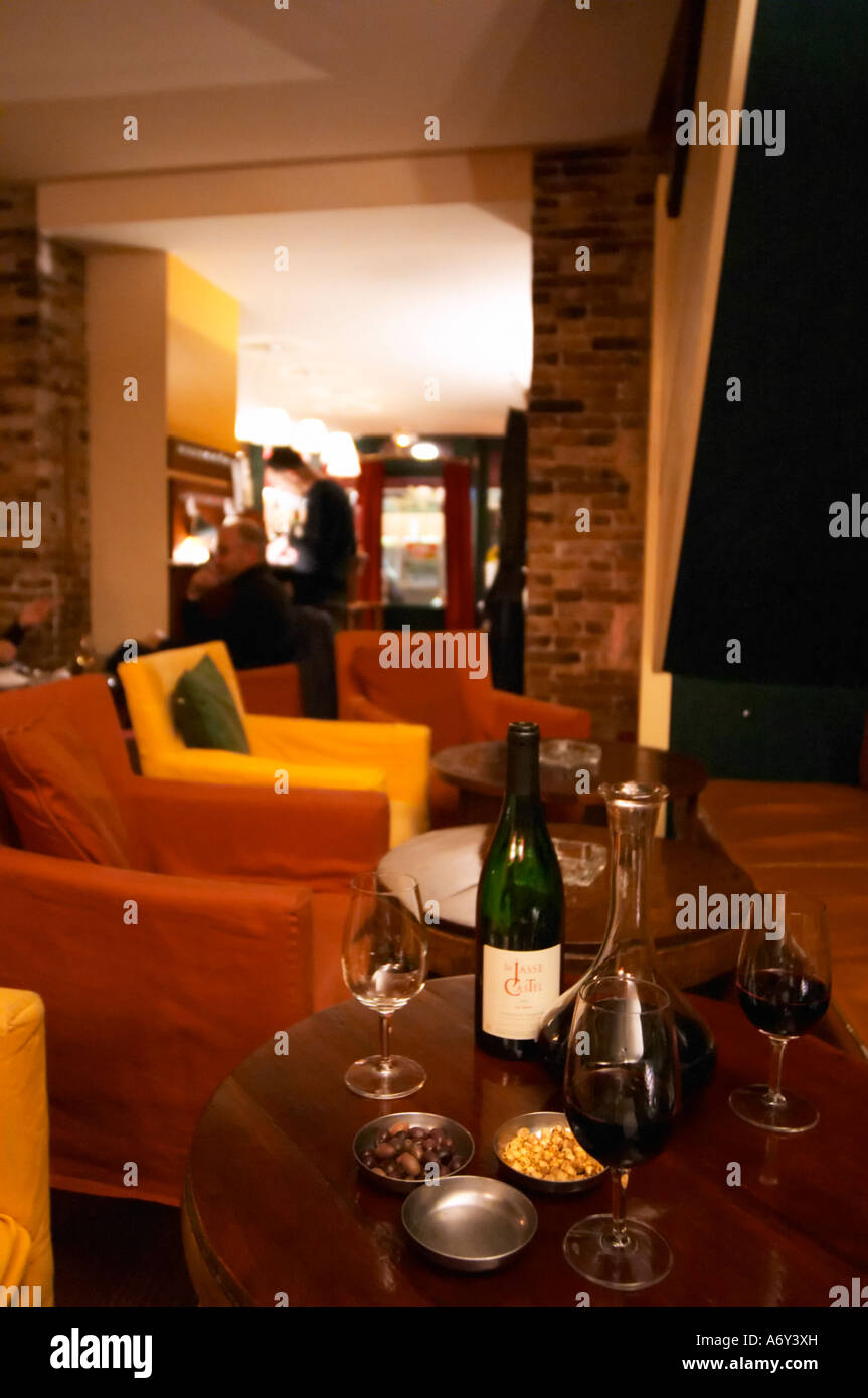 Bottle on a table with wine glasses and decanter in the wine bar Le Cafe du Passage in Paris. Domaine La Jasse Castel. Montpeyroux. Languedoc. France. Europe. Stock Photo