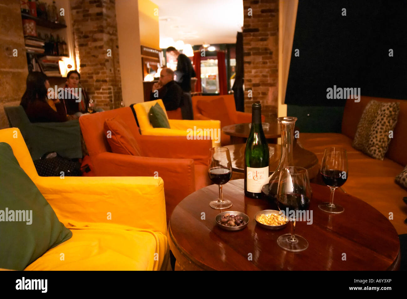 Bottle on a table with wine glasses and decanter in the wine bar Le Cafe du Passage in Paris. Domaine La Jasse Castel. Montpeyroux. Languedoc. France. Europe. Stock Photo