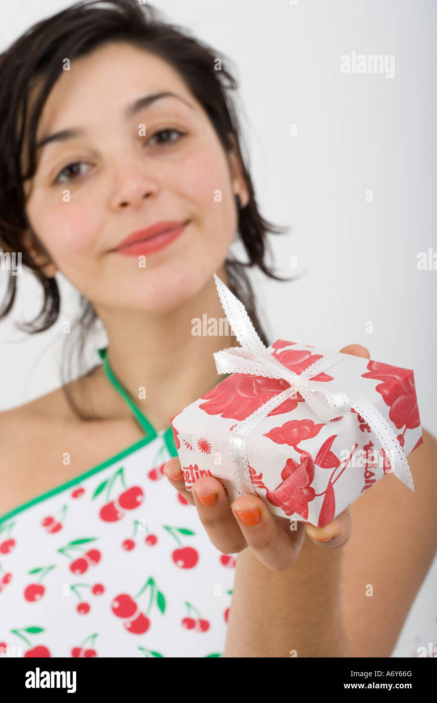 Woman looking at camera and holding present Stock Photo