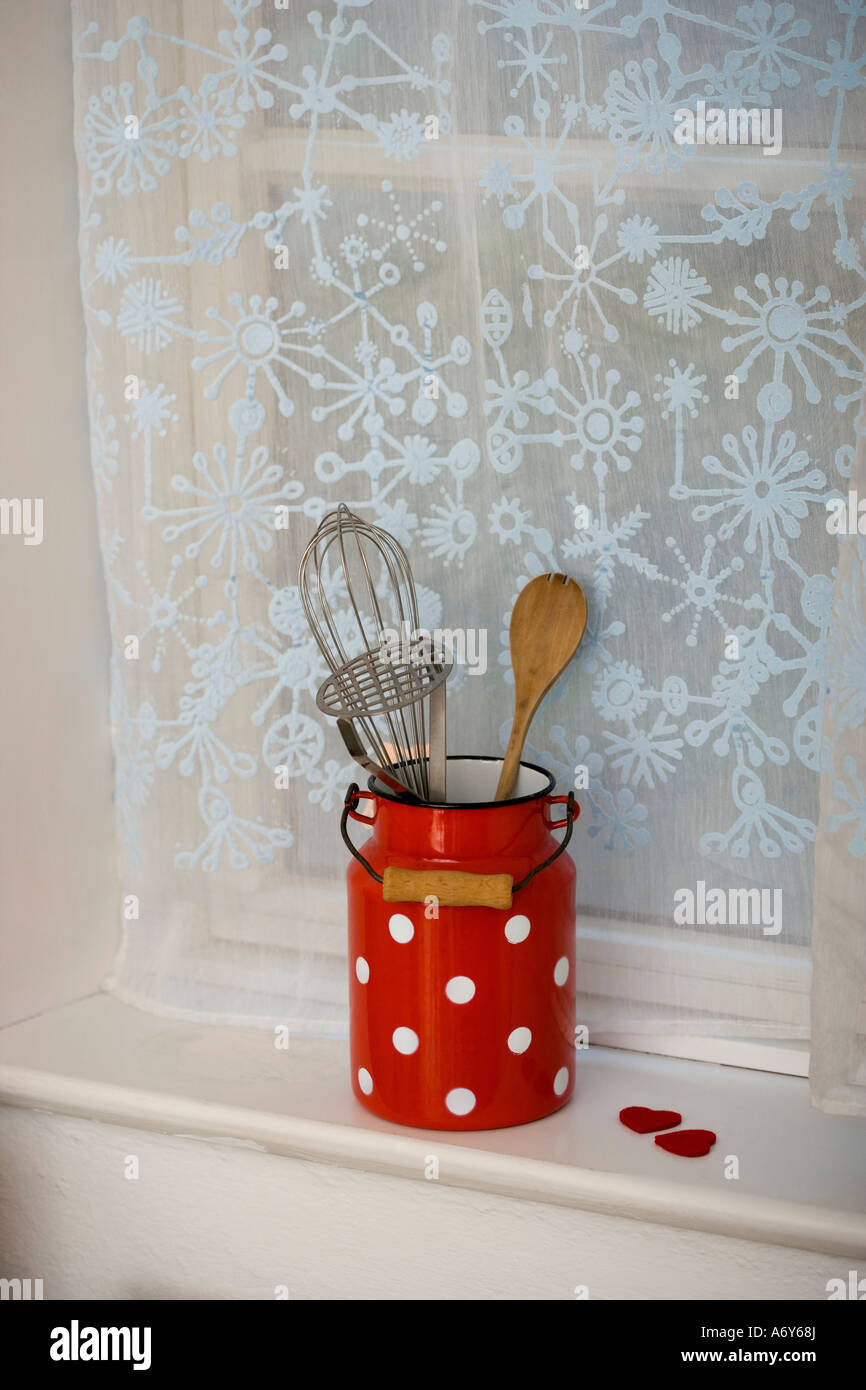 Kitchen utensils on a window sill Stock Photo