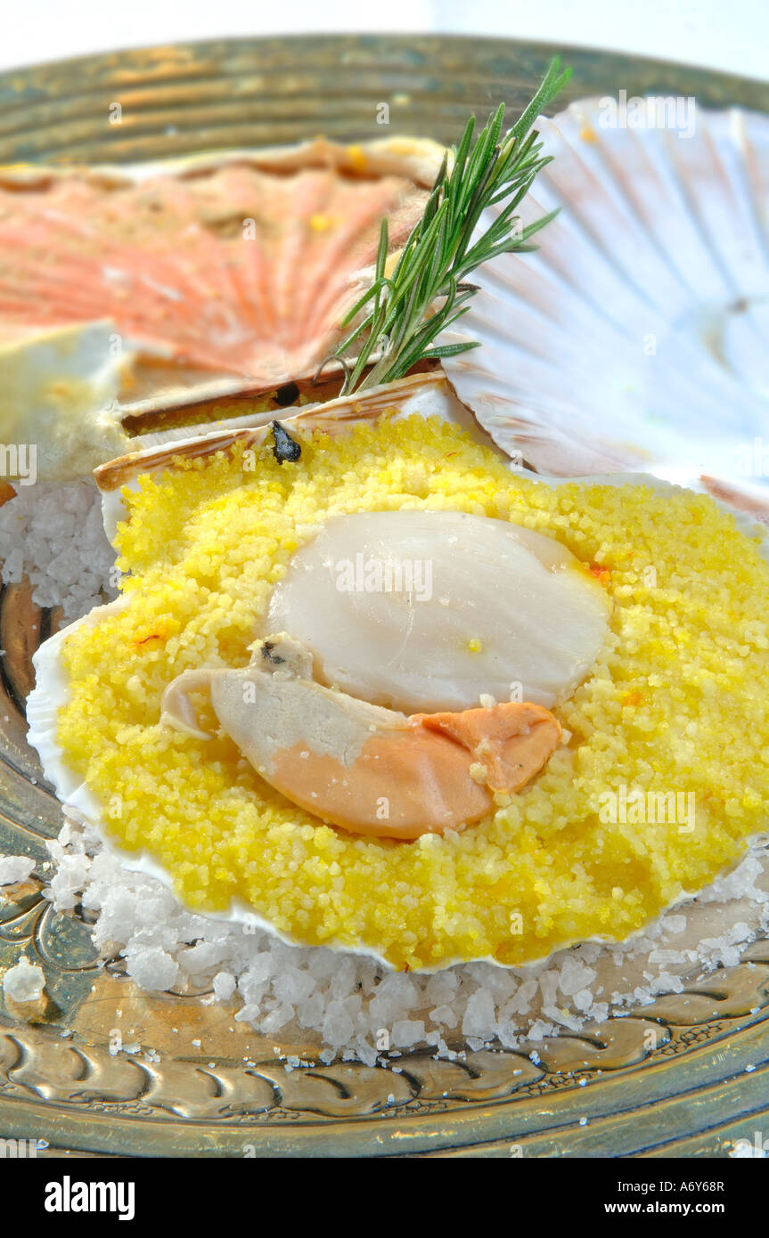 Scallops with saffron semolina cooked with shell Stock Photo - Alamy