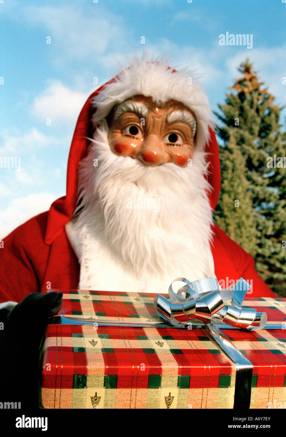 Santa Claus holding a present Stock Photo