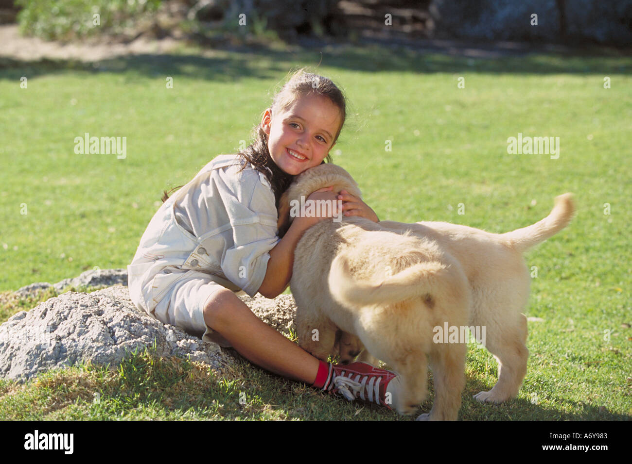 portrait of a girl sitting in the park with her dogs Stock Photo - Alamy