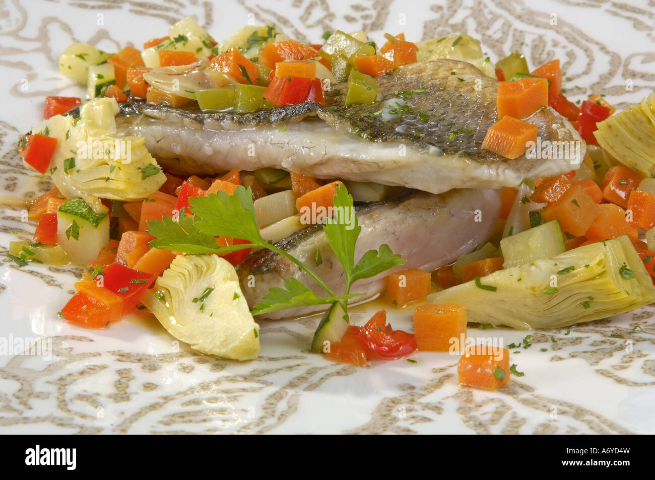 Roast sea bass with vegetable stew Stock Photo Alamy