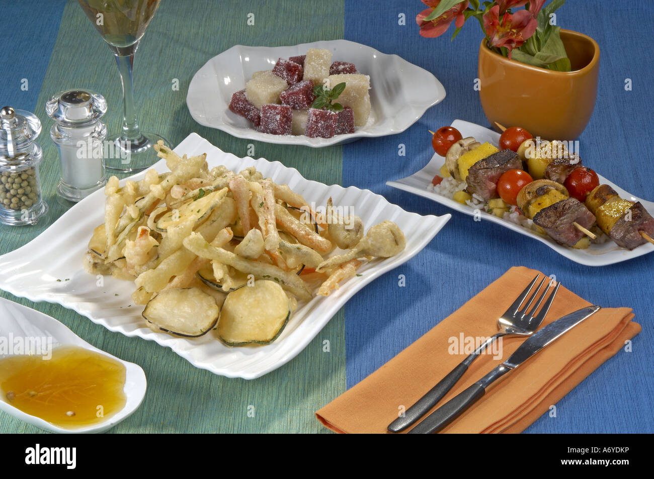 Menu of vegetable tempura and squid with lemon sauce veal brochette