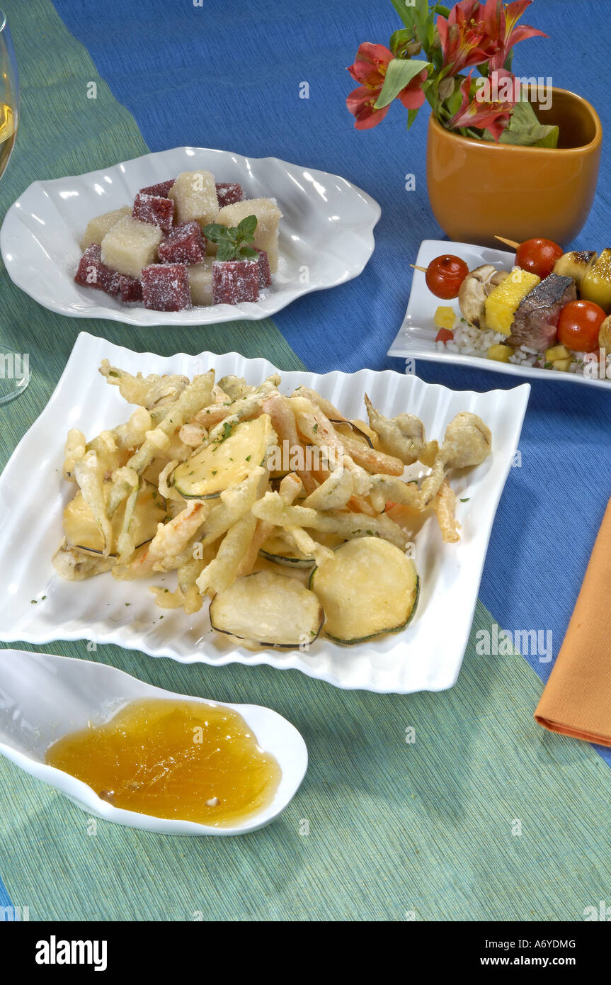 Menu of vegetable tempura and squid with lemon sauce veal brochette