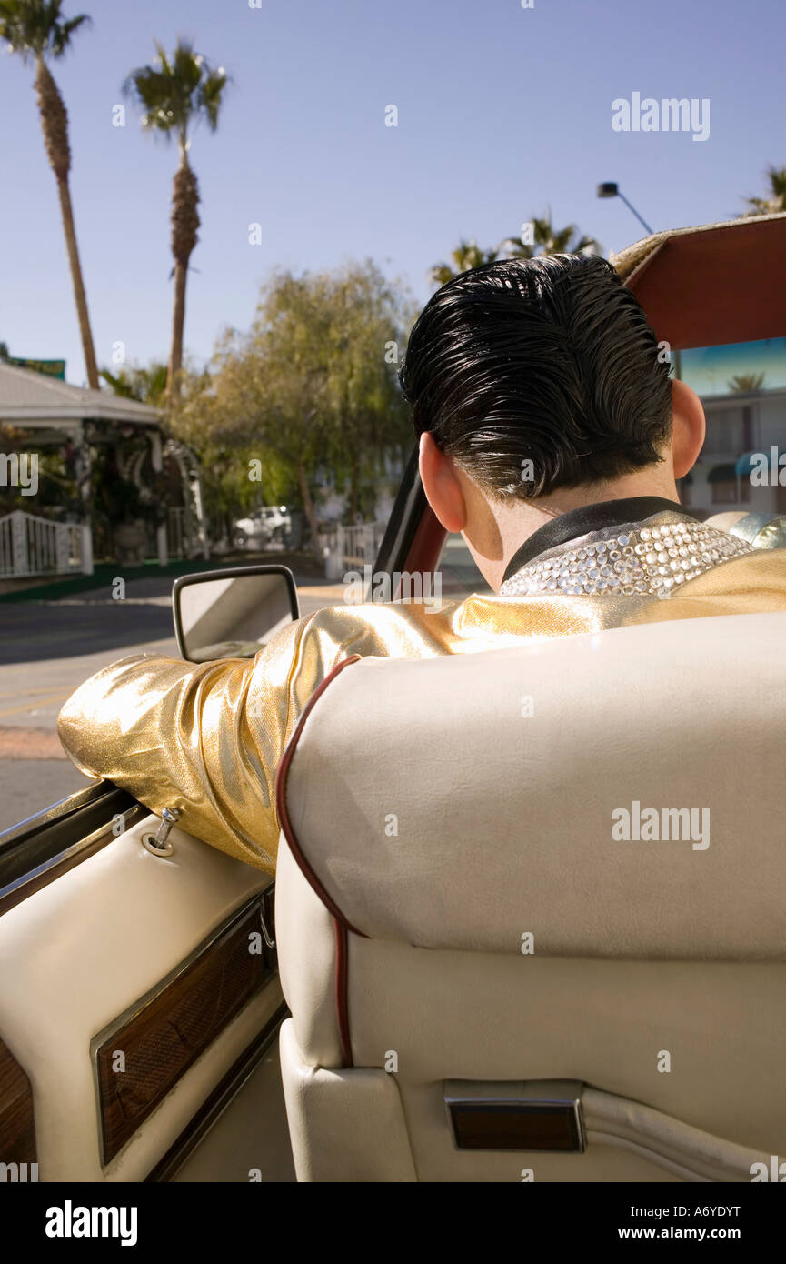 Elvis impersonator driving a vintage convertible car Stock Photo