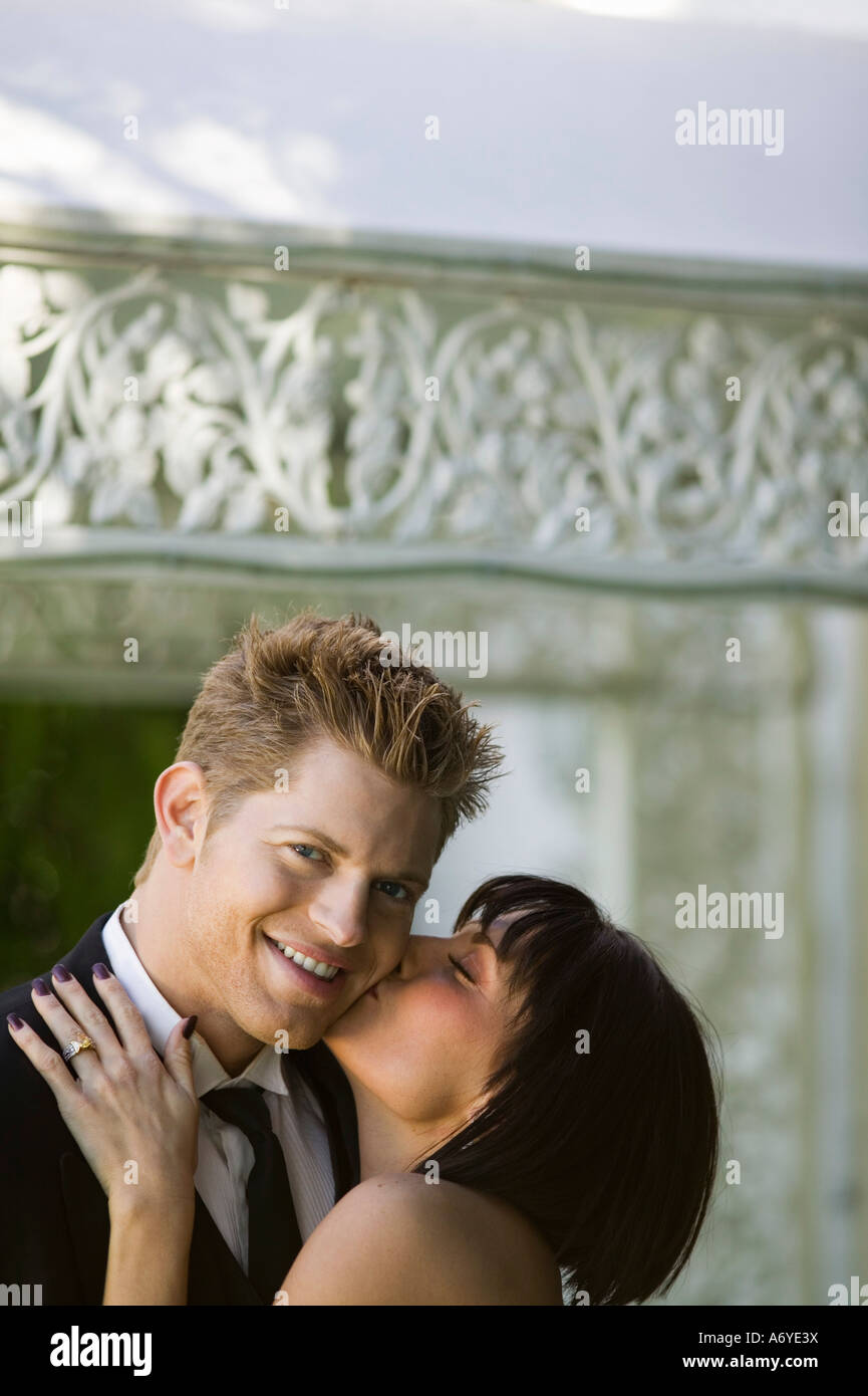 Bride kissing a groom on the cheek Stock Photo - Alamy