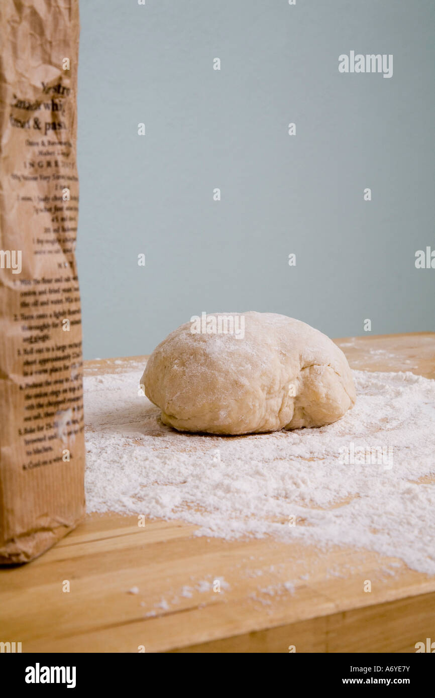 A bag of flour and a ball of dough on a kitchen counter Stock Photo