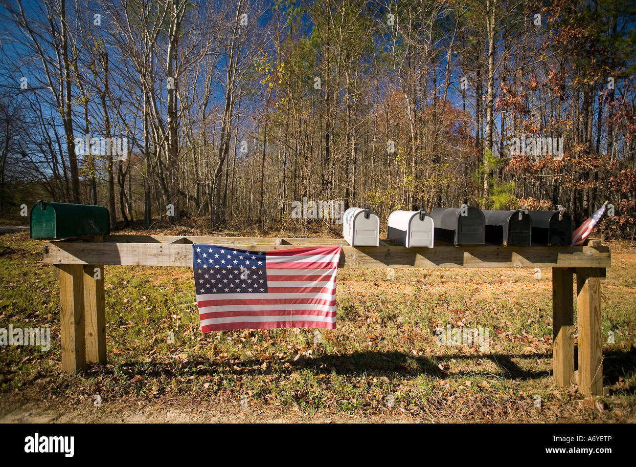 American flag hanging next to mailboxes Stock Photo
