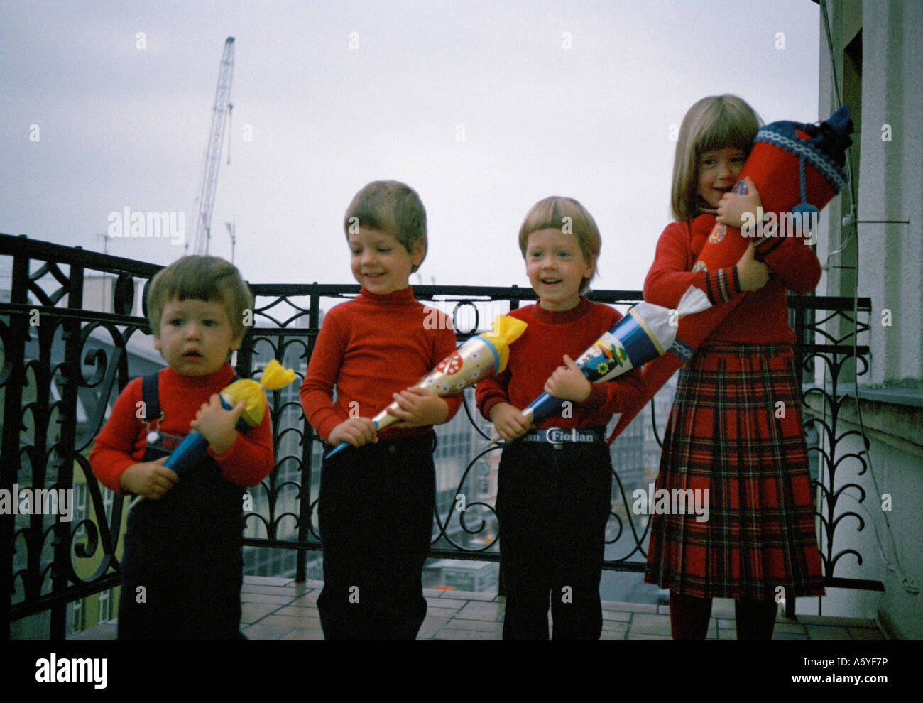 Four children standing in a row Stock Photo