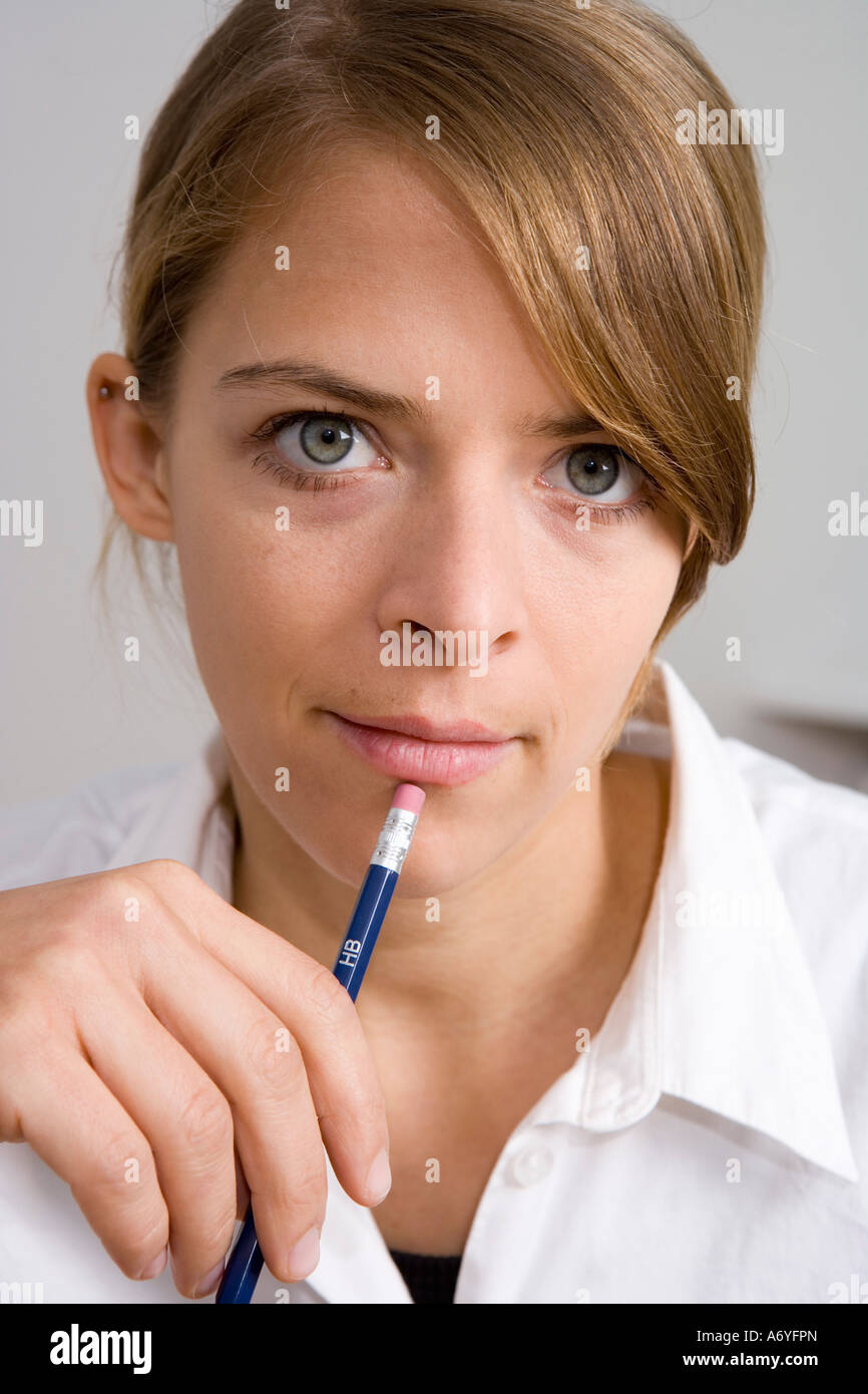 Portrait of a woman holding a pencil Stock Photo - Alamy