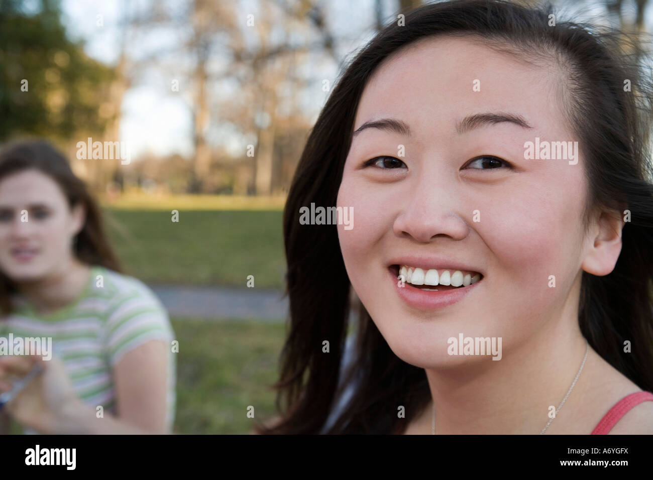 Portrait of a university student sitting on grass Stock Photo - Alamy