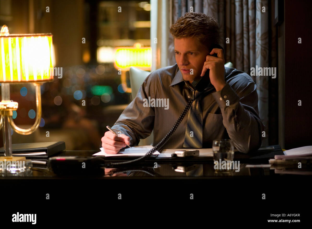 Businessman sitting at a desk and using a telephone Stock Photo
