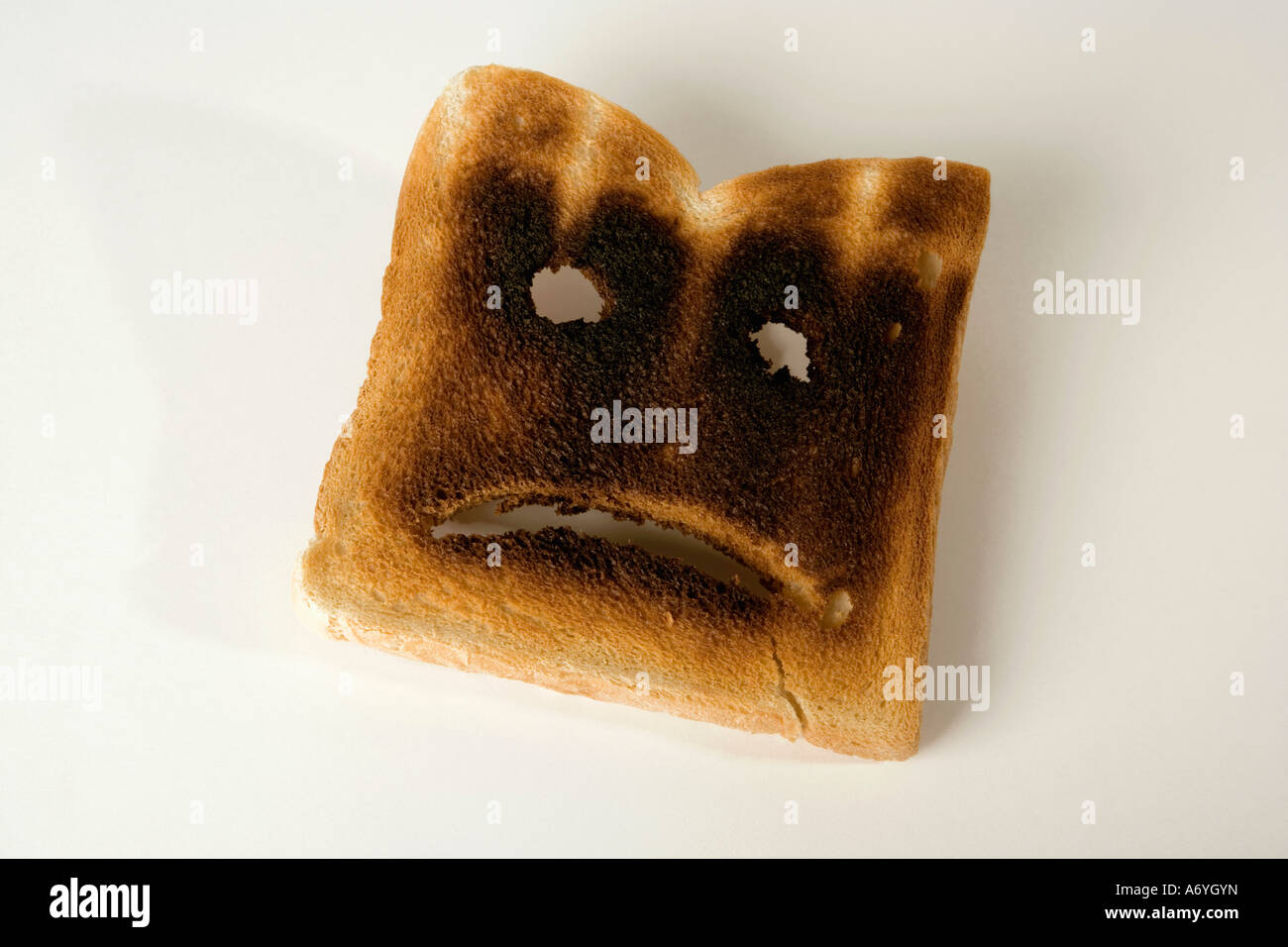 A slice of burnt toast with a sad face Stock Photo Alamy