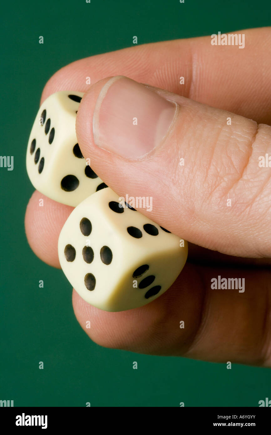 Hand holding two dice Stock Photo