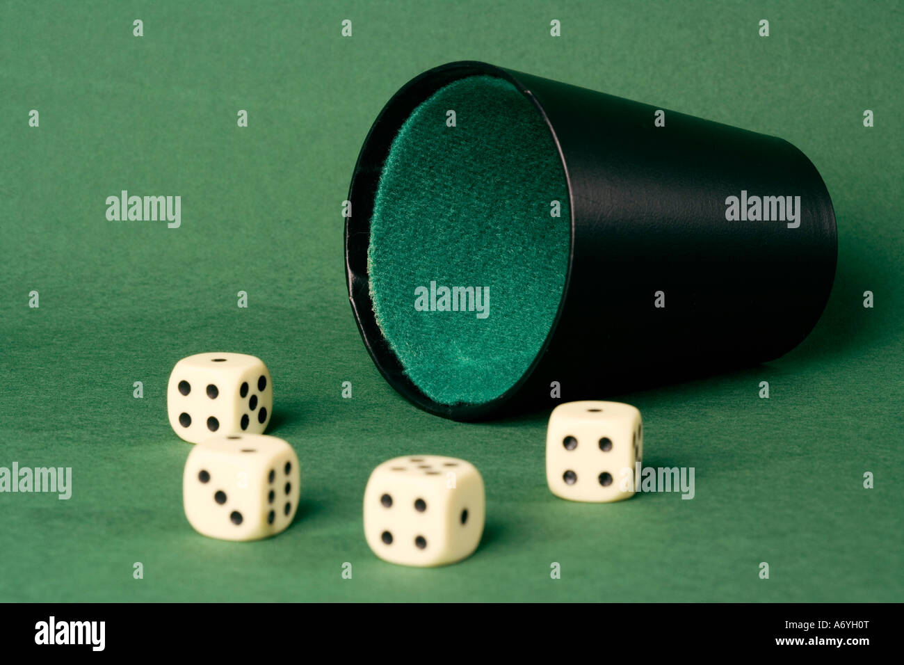 Four dice and a dice cup Stock Photo Alamy