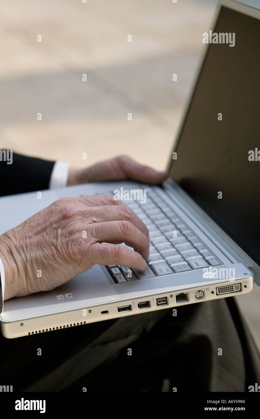 Close up of a businessman using a laptop in a park Stock Photo - Alamy