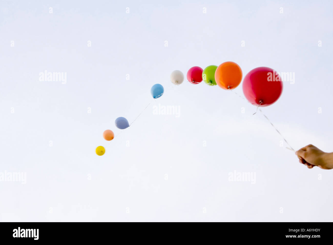 Helium balloons tied to a string Stock Photo - Alamy