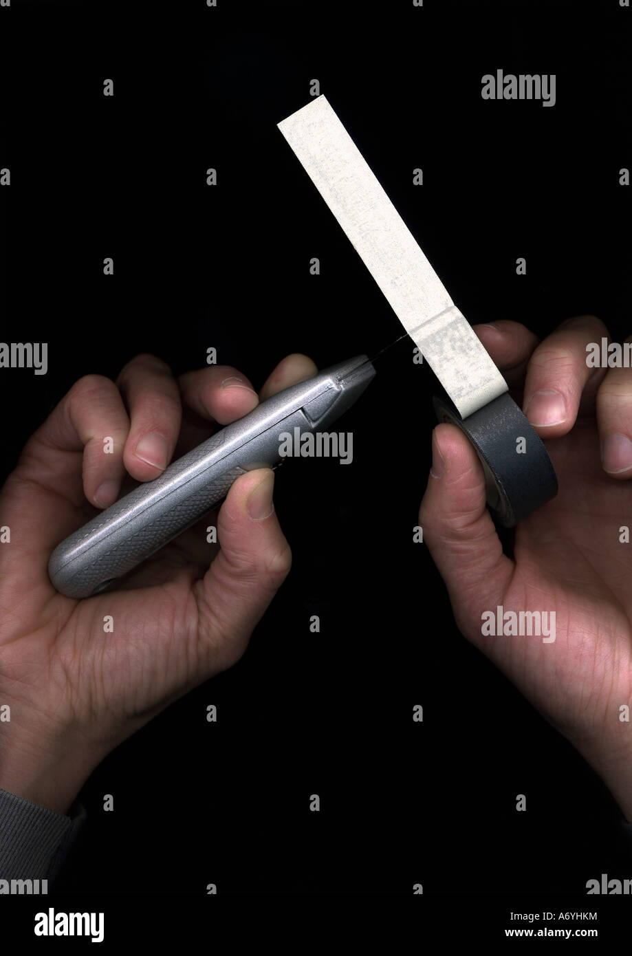Man cutting duct tape with a utility knife Stock Photo Alamy