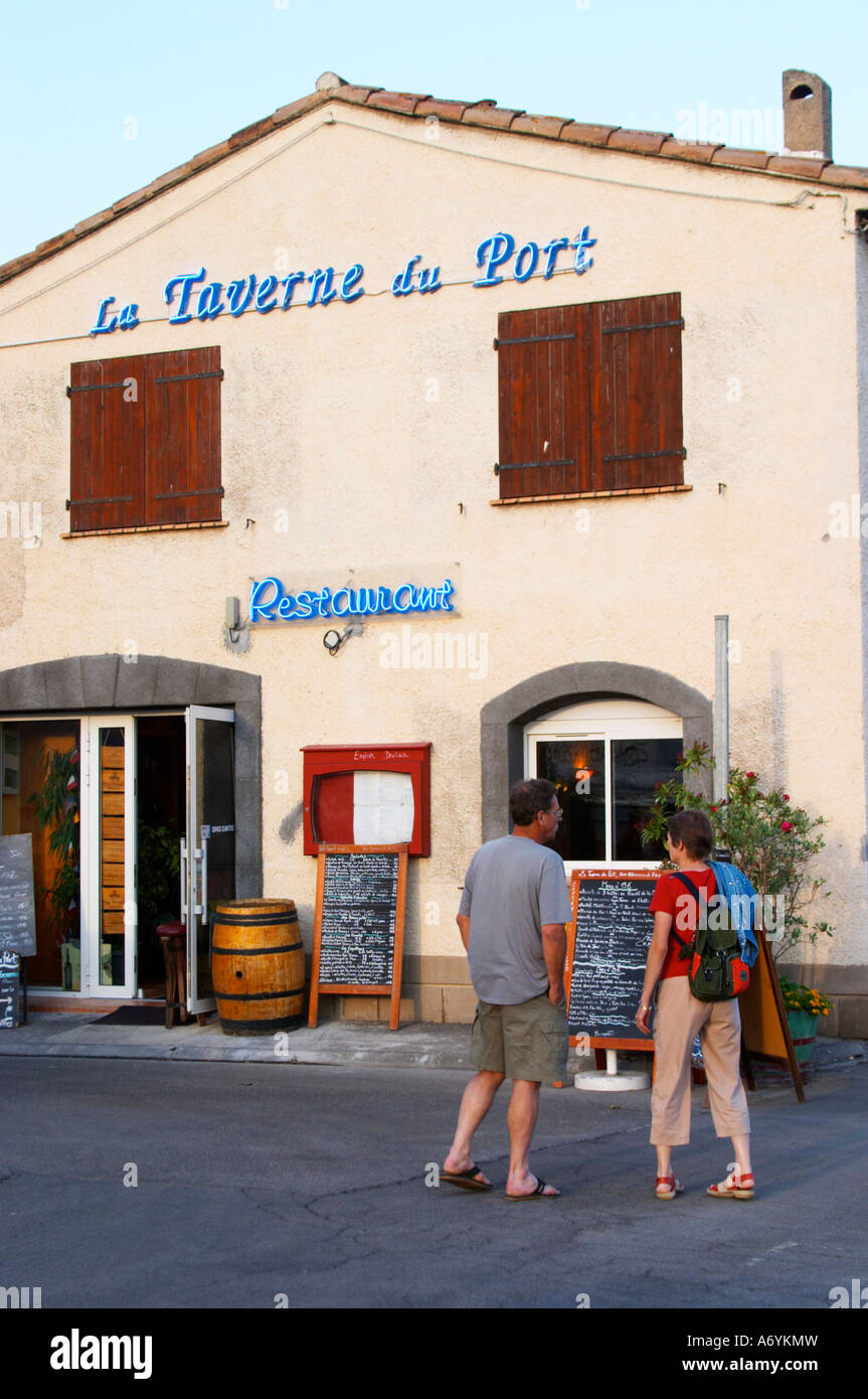 La Taverne du Port with many chalkboards with menus. A couple reading the  offers. Marseillan. Languedoc. France. Europe Stock Photo - Alamy